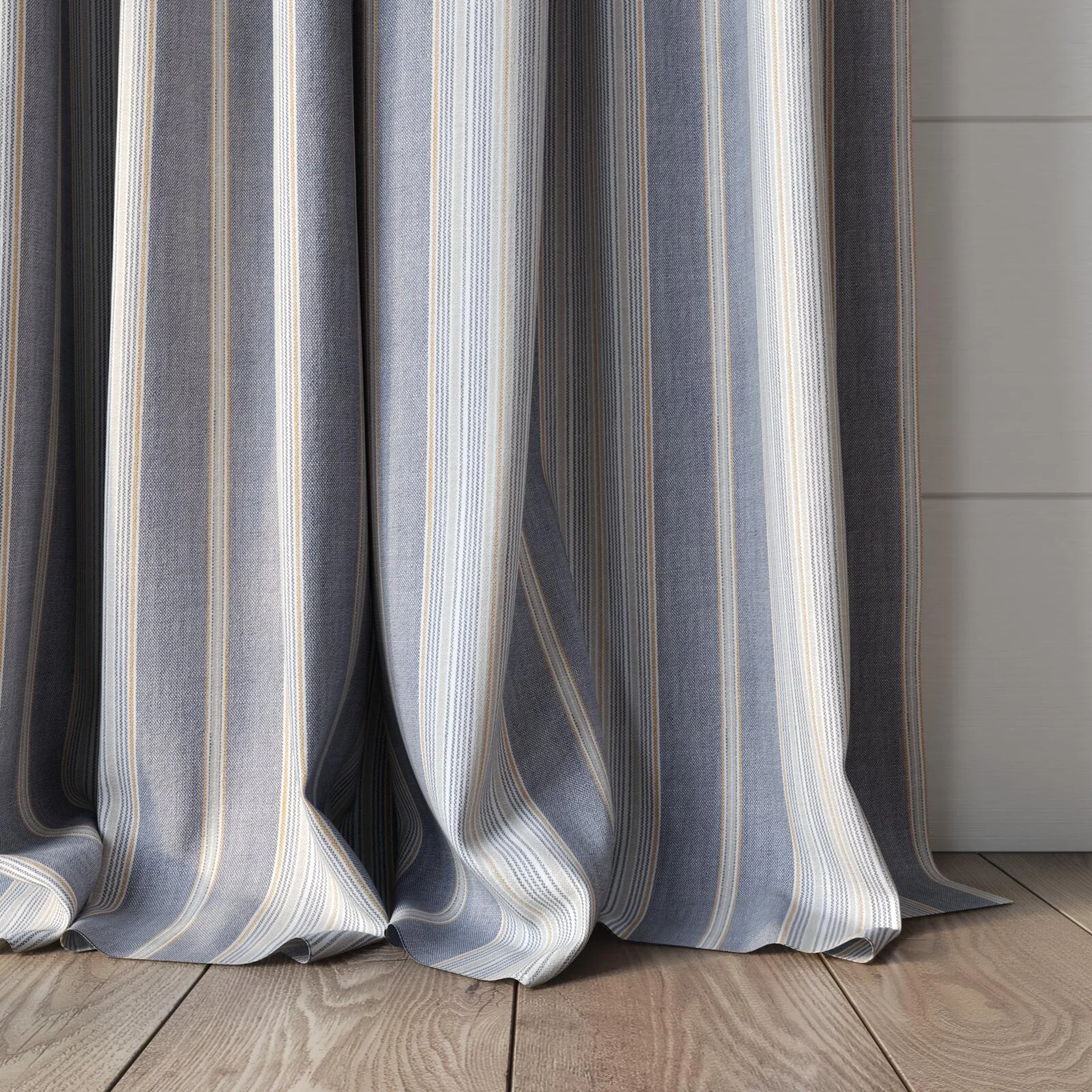 Bottom view of Chambray Multi Denim, puddled, on curtain rod