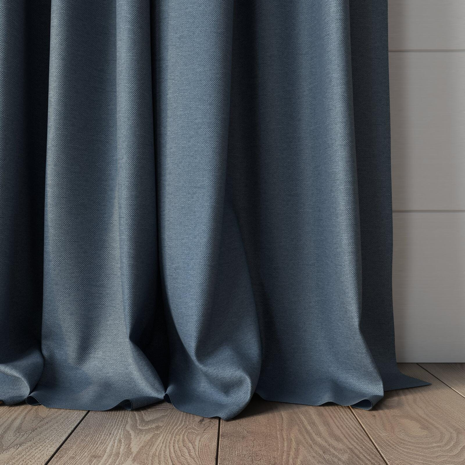 Bottom view of Duede Denim, puddled, on curtain rod