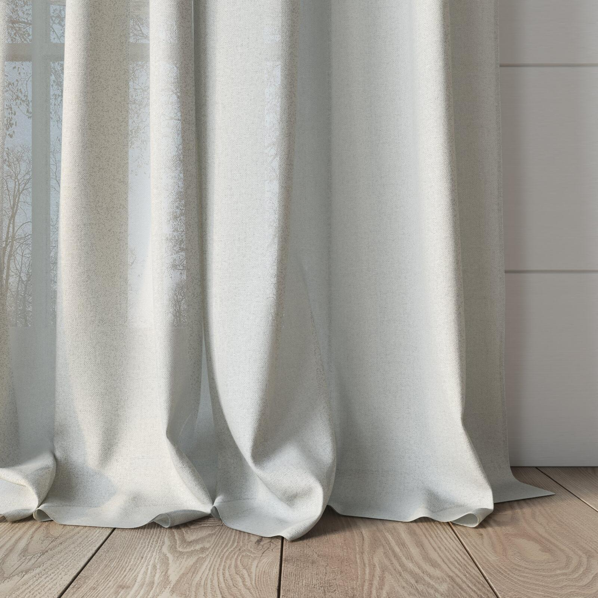Bottom view of Rava Ivory, puddled, on curtain rod