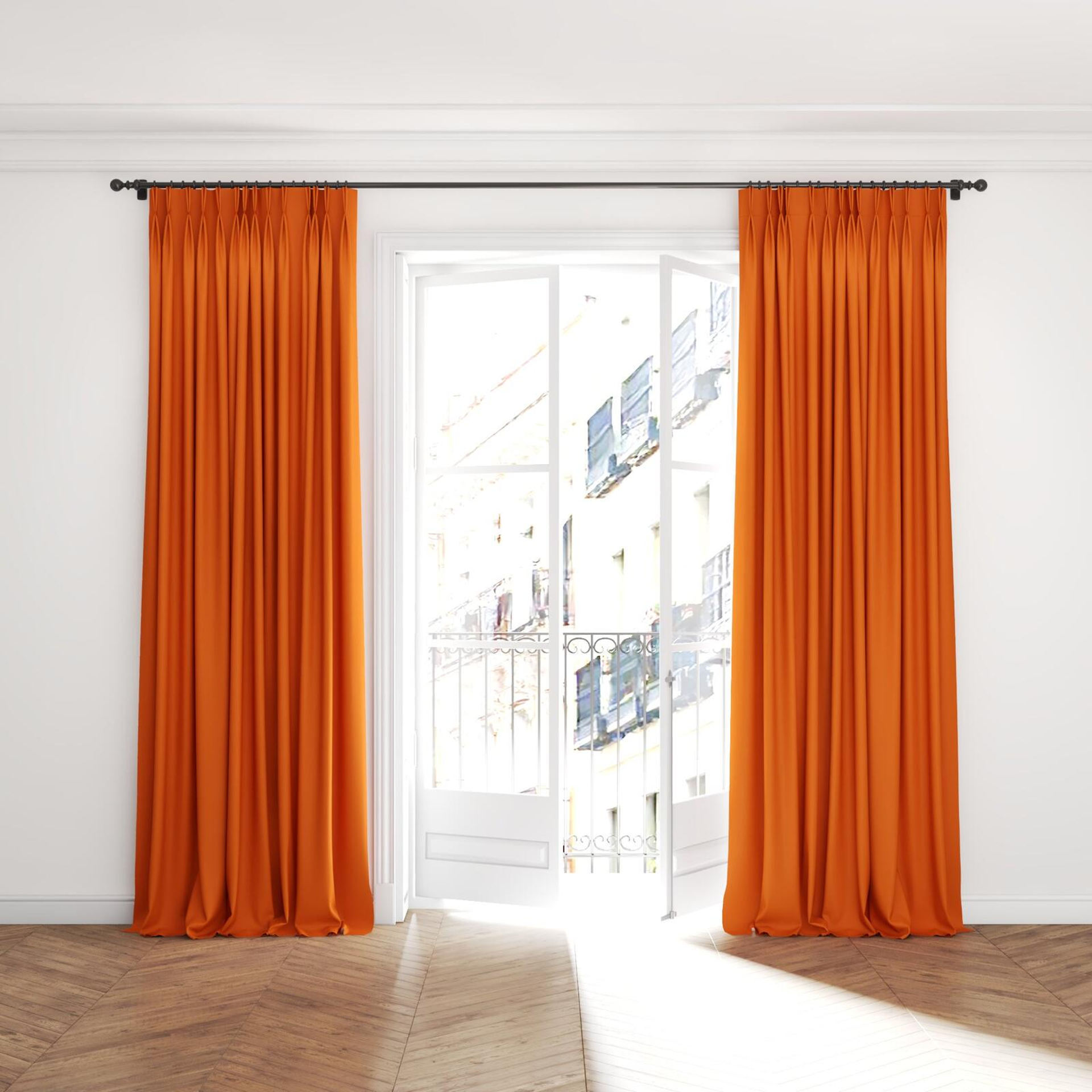 Full view of Ultra Dim Pumpkin, puddled with pinch pleat, on curtain rod